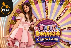 Woman in pink dress standing in front of a colorful Sweet Bonanza Candyland game wheel.